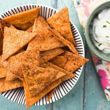 Homemade paprika tortilla chips with dip.