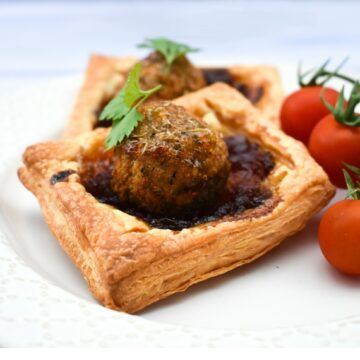 A square falafel onion pie with cherry tomatoes.